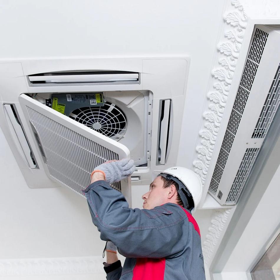 Technician repairing central air conditioning system