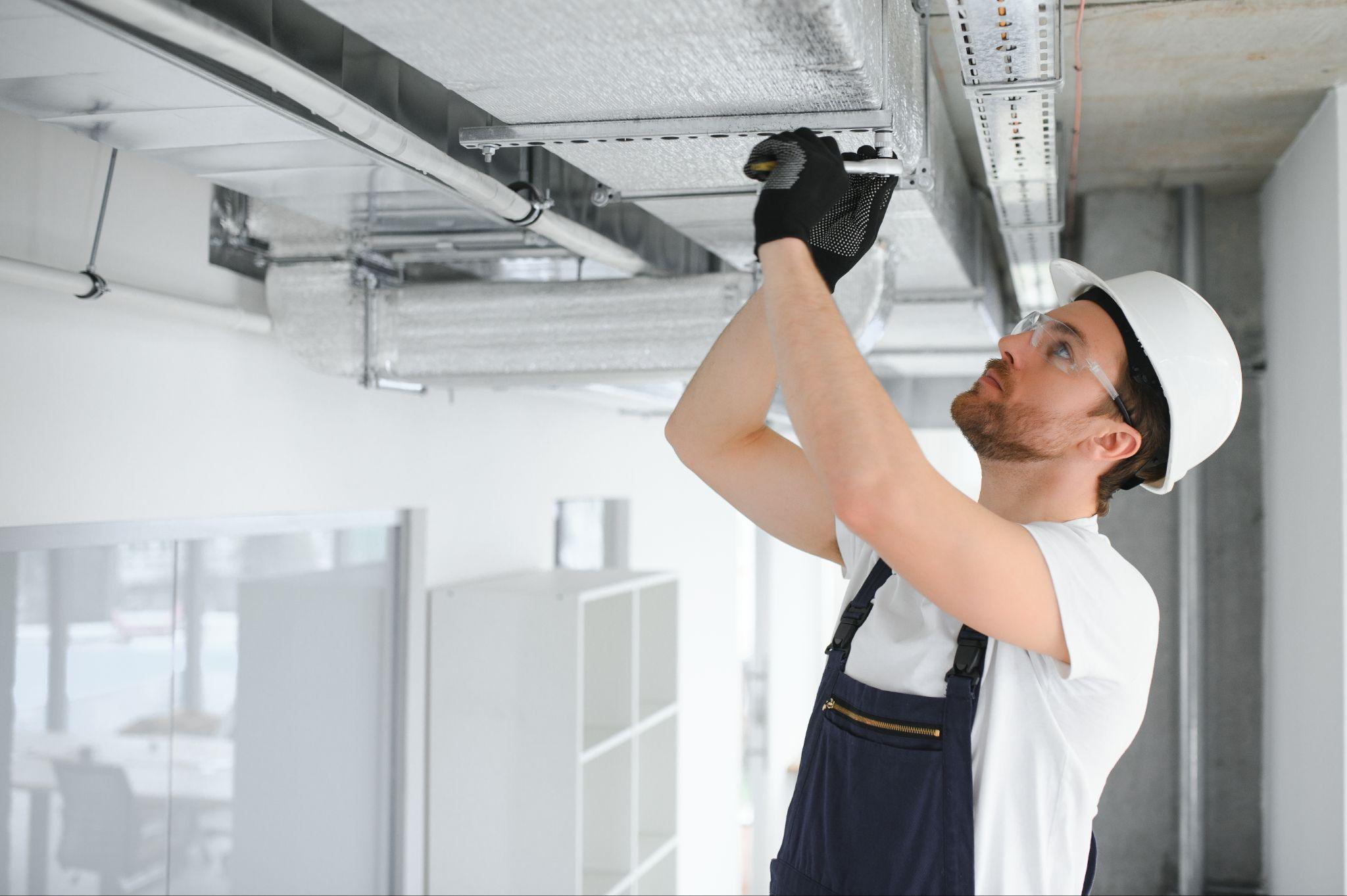 Technician servicing split system air conditioner